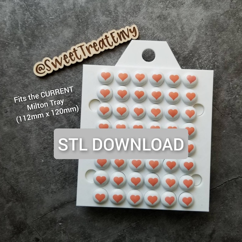 May include: A white tray with 48 pink heart-shaped candy molds. The tray is labeled "Fits the CURRENT Milton Tray (112mm x 120mm)" and "STL DOWNLOAD".