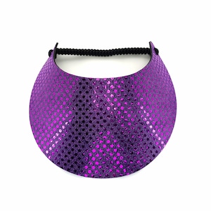 May include: A purple visor with a black elastic band. The visor is covered in small, shiny purple sequins.