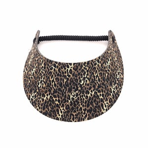 May include: A leopard print sun visor with a black elastic band.