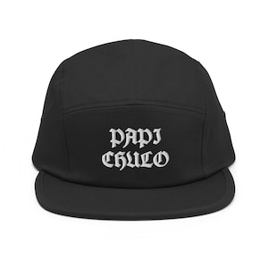 May include: Black 5-panel cap with white embroidered text that reads "papi chulo".