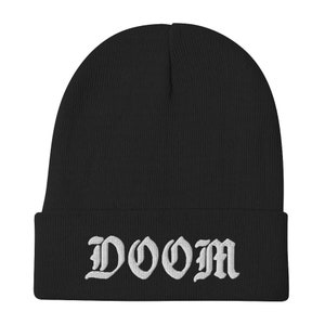 May include: Black knit beanie with a white embroidered "DOOM" in old English lettering.