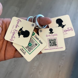 May include: A set of four cream-coloured square keychains with a black silhouette of a woman in a yoga pose. The keychains feature the text "Garden Essentials Yoni Care" and a QR code. One keychain has the text "Cash App" and a QR code.