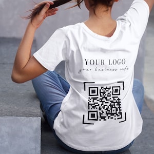 May include: White t-shirt with a black QR code and the text "YOUR LOGO your business info" printed on the back.