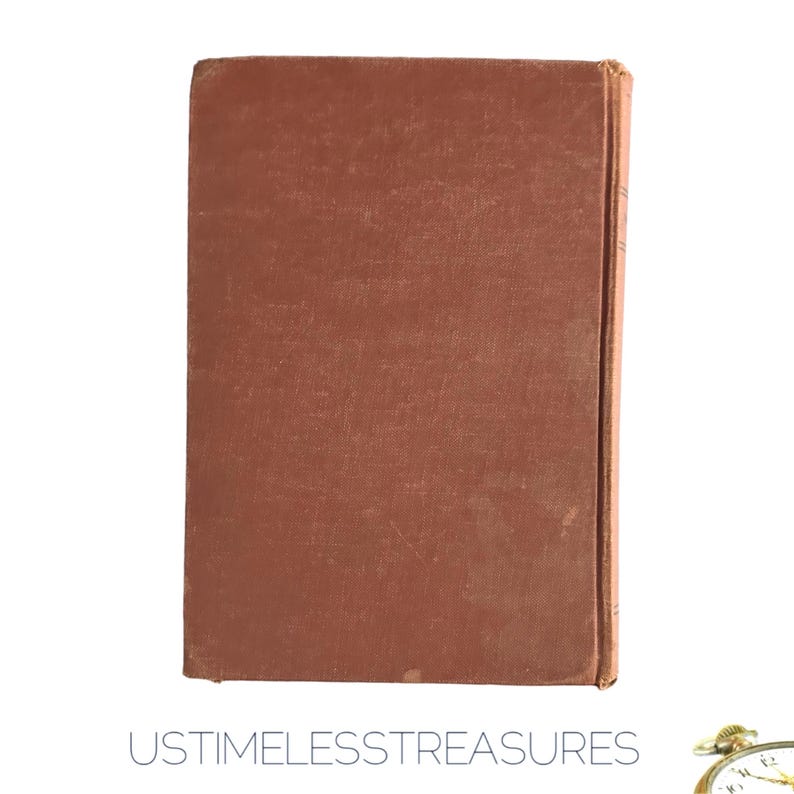 May include: A vintage book with a textured, reddish-brown cover. The spine is visible on the right side, showing signs of wear. The text "USTIMELESSTREASURES" is printed in a light gray color at the bottom of the image.