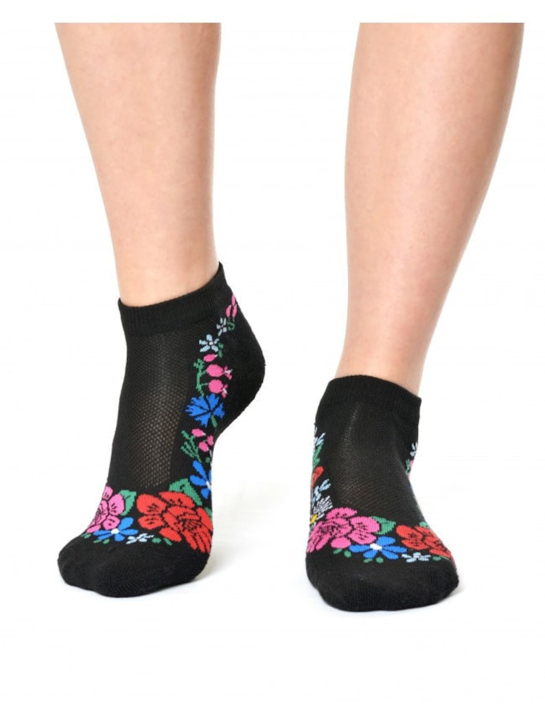 May include: Black ankle socks with a colorful floral pattern around the ankle.