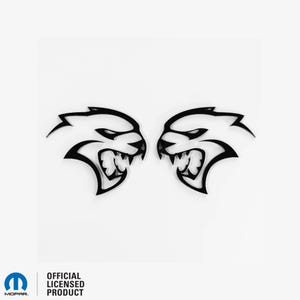 Peut inclure: Une paire de têtes de loup stylisées noires, face à face, qui grognent. Les têtes sont des images miroir l'une de l'autre.