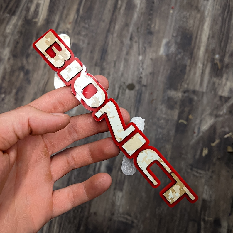 May include: A red and white camouflage sticker with the word "BioZic" printed on it.