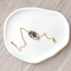 Handmade 18k gold plated blacelet with navy blue pressed flowers preserved in resin