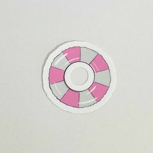 May include: A white and pink inflatable ring with a gray center. The ring is a simple design with no additional details.