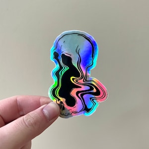 May include: A holographic sticker of a skull with a black and rainbow swirl design.