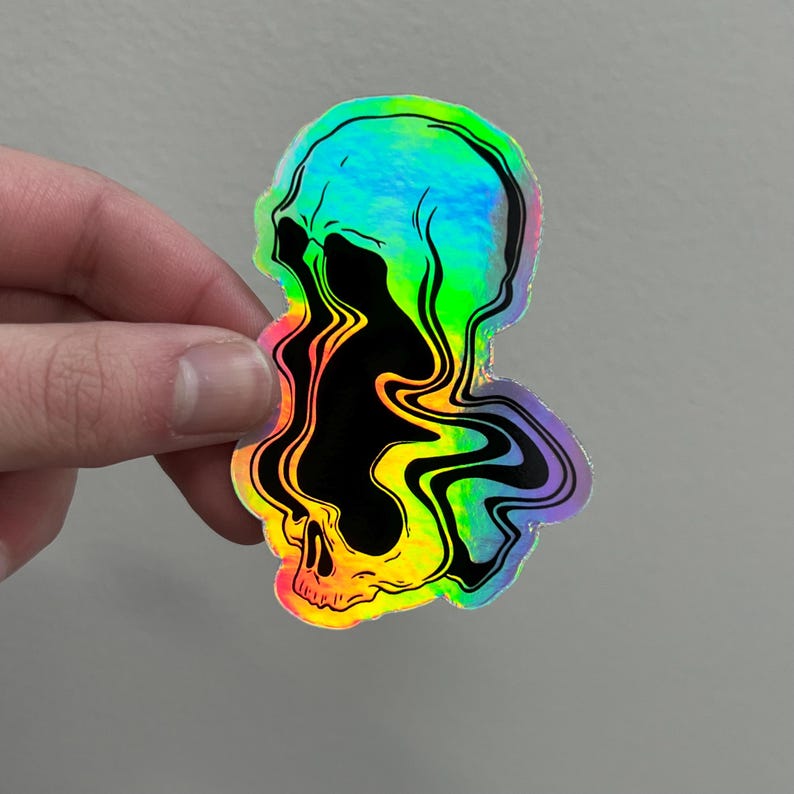 May include: A holographic sticker featuring a black and white skull with a rainbow swirl effect. The skull is melting into the swirl, creating a psychedelic design.