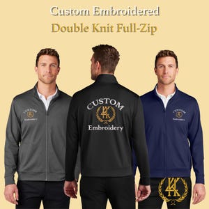 May include: Three custom embroidered double knit full-zip jackets in grey, black, and navy blue. Each jacket has a front zip, a stand-up collar, and the embroidered text "Custom Embroidery". The jackets are displayed on mannequins.