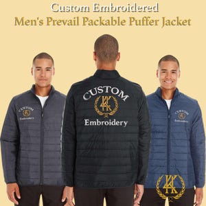May include: Three custom embroidered puffer jackets in charcoal, black, and navy blue. Each jacket features a zip-up front and the embroidered text "Custom Embroidery". The jackets have a quilted design and a stand-up collar.