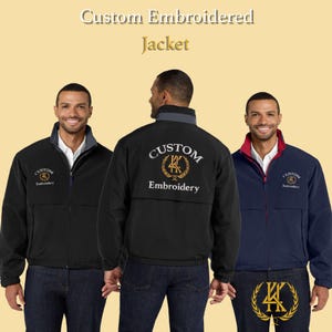 May include: Three jackets in black and navy blue with custom embroidery. The jackets have a zip-up front, a collar, and the text "Custom Embroidered Jacket" at the top. The jackets have the "Custom Embroidery" logo on the front and back.