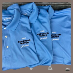 May include: Three light blue polo shirts with the text "ERIC SUPERIOR WATER HAGUE" embroidered on the front.