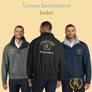 May include: Three custom embroidered jackets in gray, black, and navy blue are displayed. The jackets have a zip-up front, a collar, and the text "Custom Embroidery" with a logo. The jackets are worn by three people.