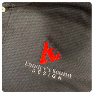 May include: Black polo shirt with a red embroidered logo that says "Landry's Sound Design".