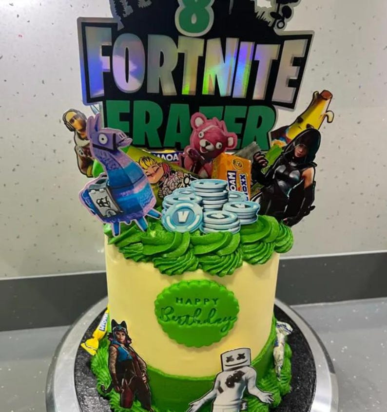 May include: A yellow and green birthday cake decorated with Fortnite characters and the words "Happy Birthday".