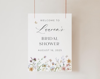 May include: White sign with black text that reads "Welcome to Lauren's Bridal Shower August 16, 2025". The sign is decorated with a watercolor floral border.