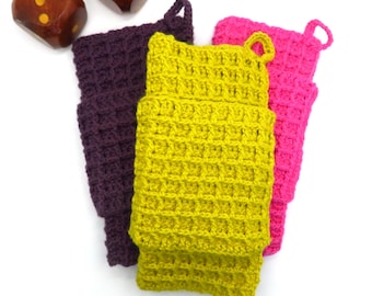 May include: Three crocheted pot holders in purple, yellow, and pink. The pot holders are made with a waffle stitch pattern.