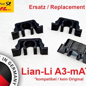 May include: Four black plastic replacement clips for a Lian-Li A3-mATX computer case. The text "Ersatz / Replacement" and "*kompatibel / kein Original" is visible in the image.
