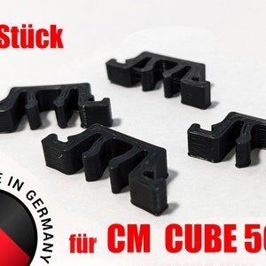 Peut inclure: Quatre clips de câble en plastique noir, conçus pour être utilisés avec le CM Cube 500. Les clips sont fabriqués en Allemagne.