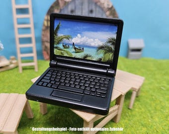 May include: A black laptop computer with a screen displaying a tropical beach scene. The laptop is sitting on a wooden table.