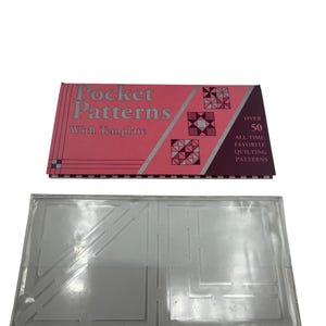 May include: A pink and silver "Pocket Patterns" booklet with a template. The booklet has the text "Pocket Patterns With Template" and "Over 50 All-Time Favorite Quilting Patterns". A clear plastic quilting template is below the booklet.