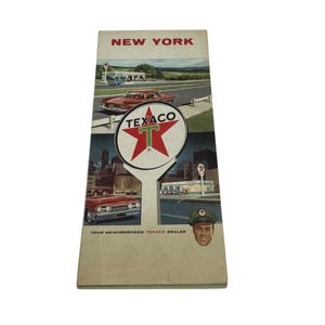 May include: Vintage New York Texaco road map. The map features illustrations of classic cars, Texaco gas stations, and the Texaco logo. The text "NEW YORK" is at the top, and "YOUR NEIGHBORHOOD TEXACO DEALER" is at the bottom.