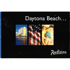 May include: A black brochure with the words "Daytona Beach..." in white. The brochure features three images: a hotel, an American flag, and a family. The Radisson logo is in the bottom right corner.
