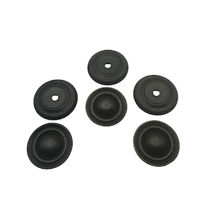 May include: Six dark bronze cabinet knobs with a circular design. Each knob has a slightly domed center and a small hole in the middle. The knobs are arranged on a white background.