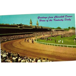 May include: A vintage postcard showing a horse race at Churchill Downs, home of the Kentucky Derby. The scene features a dirt track, a large grandstand with twin spires, and crowds of spectators. The text reads: Greetings from Churchill Downs Home of the Kentucky Derby.