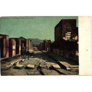 May include: A white ceramic mug with a black handle and the text "But First, Coffee" in a black, bold font. The mug is sitting on a wooden surface. The mug is approximately 4 inches tall.