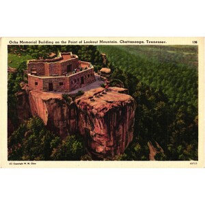 May include: A vintage postcard featuring the Ochs Memorial Building on the Point of Lookout Mountain in Chattanooga, Tennessee. The stone structure sits atop a high cliff overlooking a dense green forest, with text printed at the top and bottom.