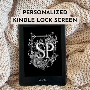May include: A black and white Kindle e-reader with a personalised lock screen featuring the initials "SP" surrounded by floral designs. The screen displays the word "kindle" at the bottom.