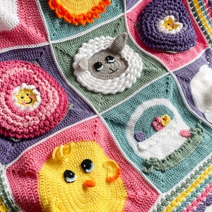 May include: A colorful crocheted baby blanket with a variety of Easter-themed motifs, including a chick, a lamb, a flower, a basket, and a sun.
