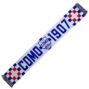 May include: White scarf with blue and red chequered ends and fringe. The scarf has the words "COMO 1907" in blue, with a crest in the centre. The crest has the words "COMO 1907" and a blue wave design.