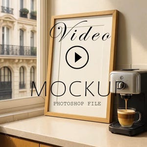 May include: A wooden framed video mockup with the word "Video" in a script font and a play button icon. The word "MOCKUP" is below the play button. A coffee machine is next to the frame, with a cup of coffee.