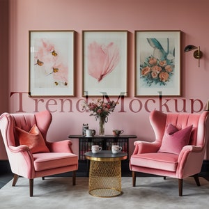 May include: Two pink velvet wingback chairs with pink pillows, a gold wire mesh coffee table with two white mugs, and a black console table with a vase of pink flowers and decorative items in a pink room with three framed prints on the wall.