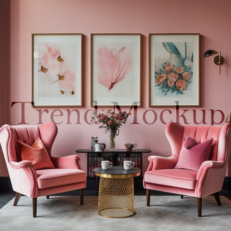 May include: Two pink velvet wingback chairs with pink pillows, a gold wire mesh coffee table with two white mugs, and a black console table with a vase of pink flowers and decorative items in a pink room with three framed prints on the wall.