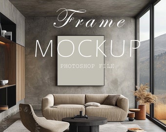 May include: A modern living room interior with a large, framed picture mockup on a gray wall. The room features a beige sofa, a brown armchair, a coffee table, and a potted plant. The window offers a view of a mountain landscape.