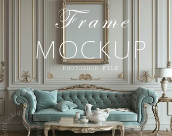 May include: A gold ornate frame mockup in a living room setting. The frame is hanging on a wall with a light grey background. A teal blue sofa with a tufted design is in the foreground. The sofa has a throw pillow and a white tea set on a coffee table in front of it.