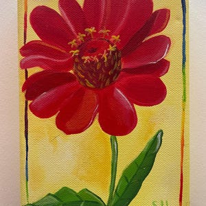 May include: A vibrant painting of a red zinnia flower on a yellow background. The flower has multiple petals and a dark center with yellow stamens. A green stem and leaves extend from the flower. The canvas is framed with a colorful border.