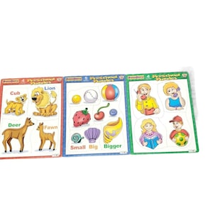 Puede incluir: Tres coloridos rompecabezas preescolares con ilustraciones de animales y objetos. Los rompecabezas presentan un león, un ciervo, un cervatillo, una pelota de béisbol, una fresa, una cereza y personas. Cada rompecabezas tiene un número diferente.
