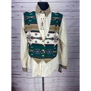 May include: A tan, green, white, red, and blue patterned vest with a white button-up shirt. The vest has a Southwestern design.
