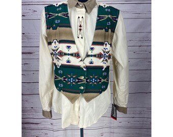 May include: A tan, green, white, red, and blue patterned vest with a white button-up shirt. The vest has a Southwestern design.