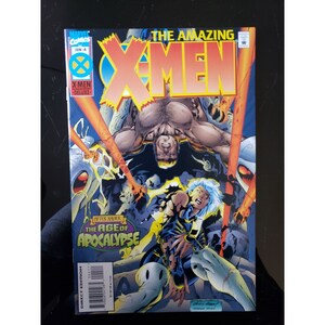 May include: Comic book cover featuring the X-Men. The cover art shows a yellow and red background with the X-Men logo in the center. The title "The Amazing X-Men" is written in large, bold letters above the logo. The cover also features a character from the X-Men, Storm, in a blue and black costume, with her powers activated. The text "The Age of Apocalypse" is written in a green box in the lower left corner of the cover.