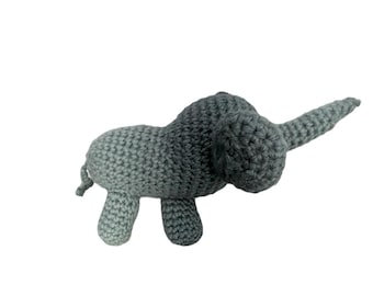 May include: A handmade, gray crocheted elephant toy. The elephant has a long trunk, small ears, and stubby legs. The toy is made of soft yarn and is suitable for children.