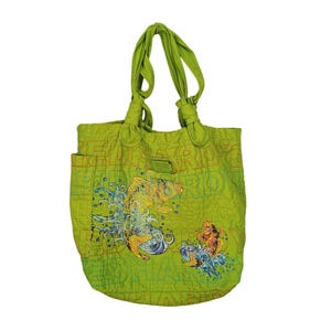 May include: Lime green tote bag with a fish graphic. The bag has a quilted design with orange stitching and a small side pocket. The fish graphic is in yellow, orange, and blue. The bag has knotted handles.