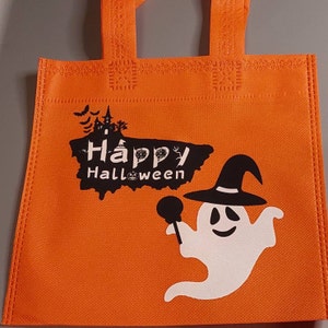 May include: Orange reusable tote bag with a white ghost holding a lollipop and the text "Happy Halloween".